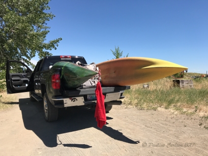 Photo of truck loaded with kayaks and red warning flag