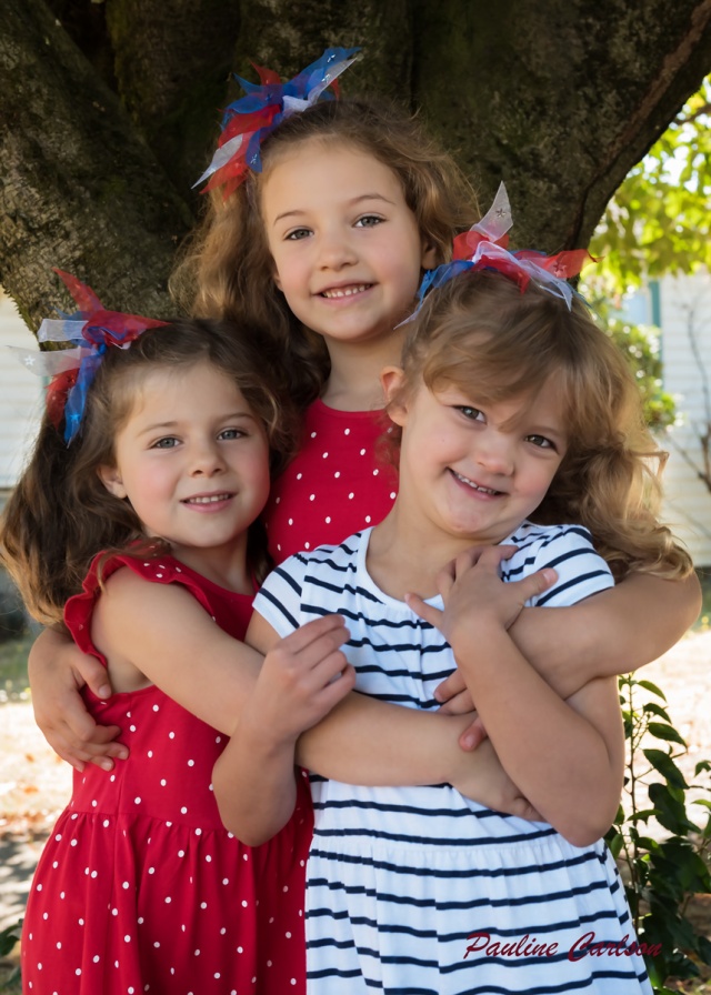 Photo of three girls in front of a tree
