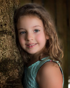 Photo of girl in front of tree