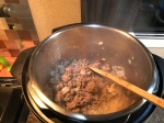 Photo of hamburger and onion cooking in an Instant Pot.