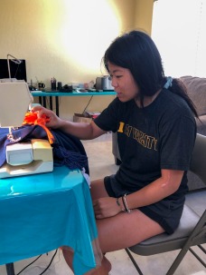 Pauline’s Photography Misty-Jade sewing tassels onto her blanket.